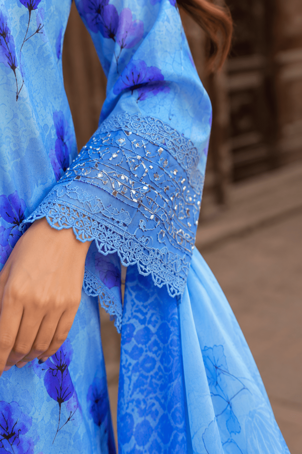 Close-up sleeve detail of sky blue floral lawn suit showcasing intricate embroidery, lace finishing, stitching quality and designer cuff embellishments