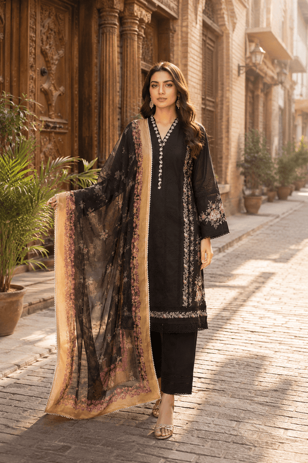 Luxury Pakistani black embroidered lawn suit with printed chiffon dupatta, front view model walking in Old Lahore heritage street, premium women's unstitched summer collection.