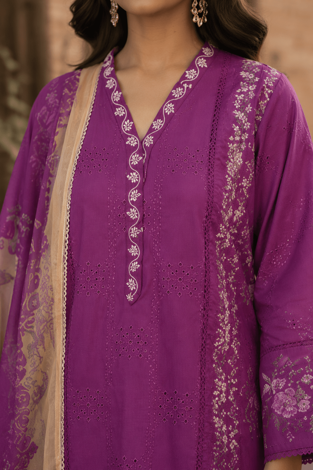 Close-up neckline and front embroidery detail of purple Pakistani lawn shirt featuring lace finishing, premium stitching and intricate floral craftsmanship.