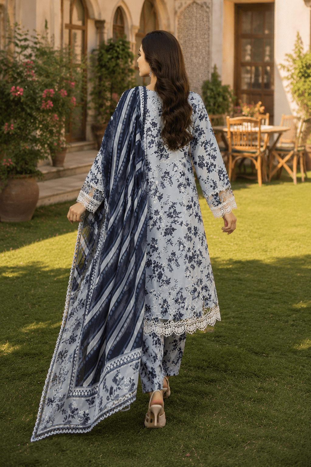 Back view of Mehrbano floral grey printed Pakistani lawn suit with contrast blue dupatta and matching trousers.