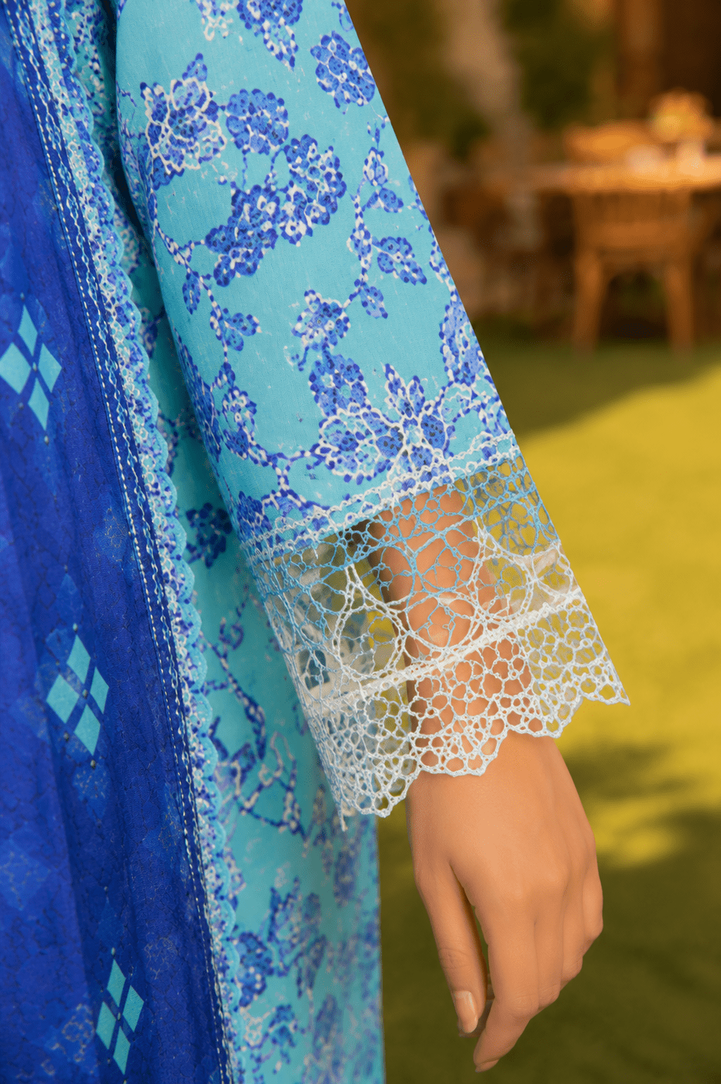 Close-up sleeve and cuff detail of Mehrbano aqua blue printed lawn suit showcasing lace trim and premium fabric craftsmanship.